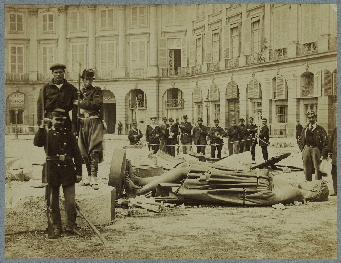 La Commune de Paris, 1871. Groupe devant les débris de la colonne Vendôme abattue par les fédérés le 16 mai 1871, 1er arrondissement, Paris.  Braquehais, Auguste Bruno , Photographe (© Musée Carnavalet - Histoire de Paris)